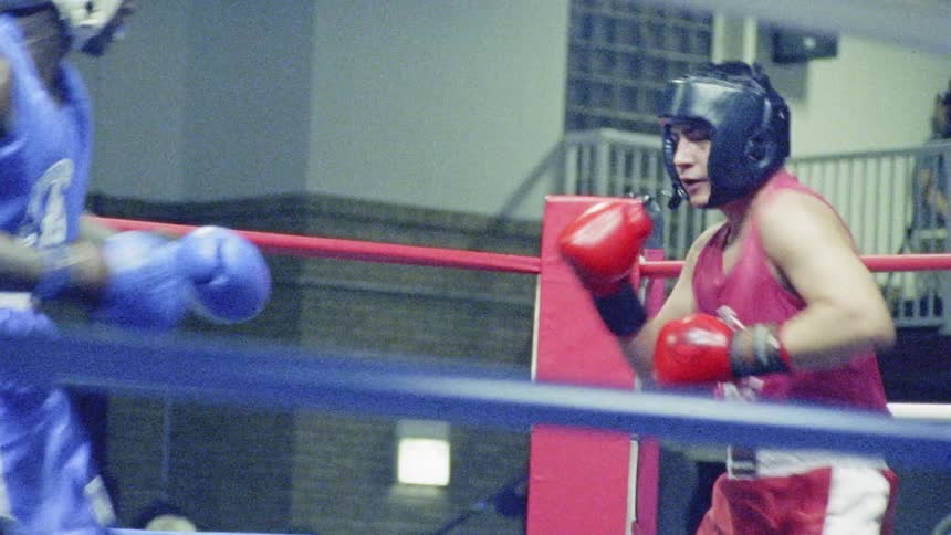 Two men fighting in a boxing ring