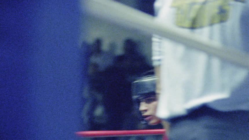 Two men are boxing in front of a crowd