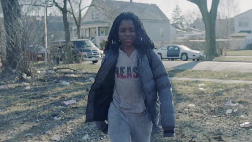 A girl is taking a shortcut through a neighbor