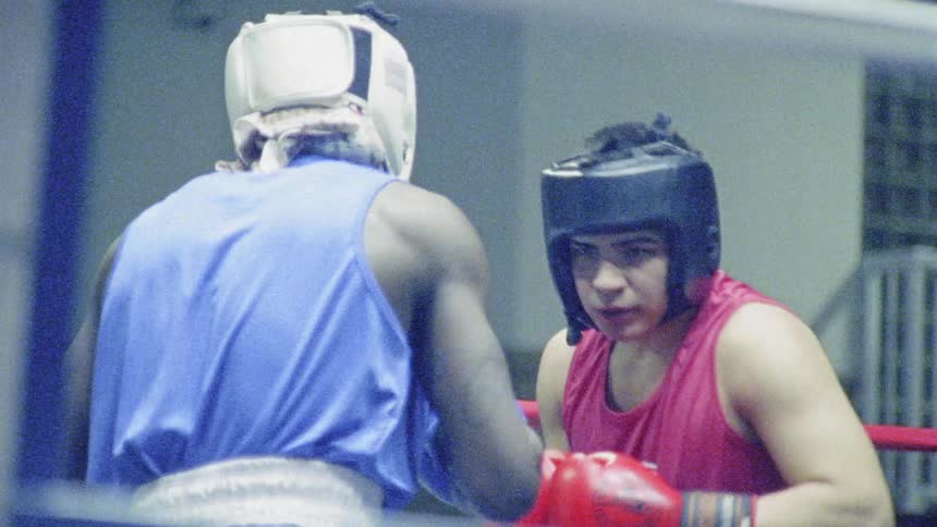 Two people box and hit each other in the ring