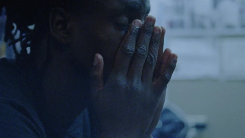 A man rubs his face in his hands