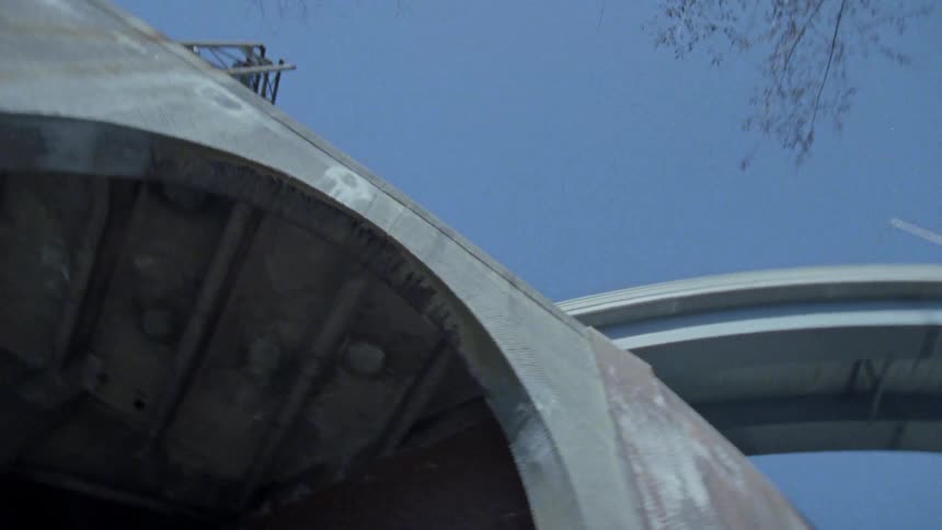 Large cement structure sits under a sunny blue sky