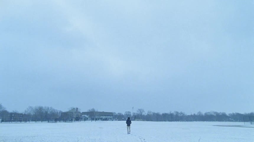 A person hikes over the snow covered field
