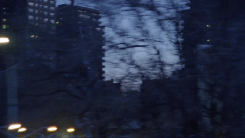 The city has many buildings with lights on inside at dawn