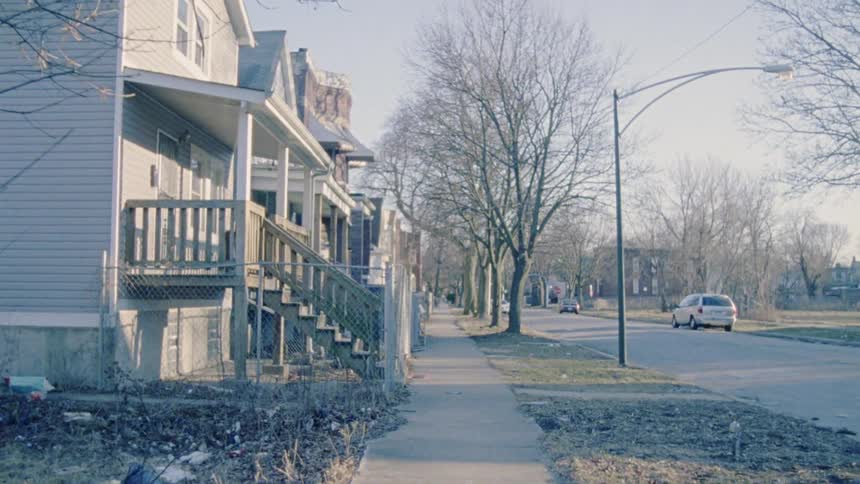 Camera view walking on sidewalk near homes
