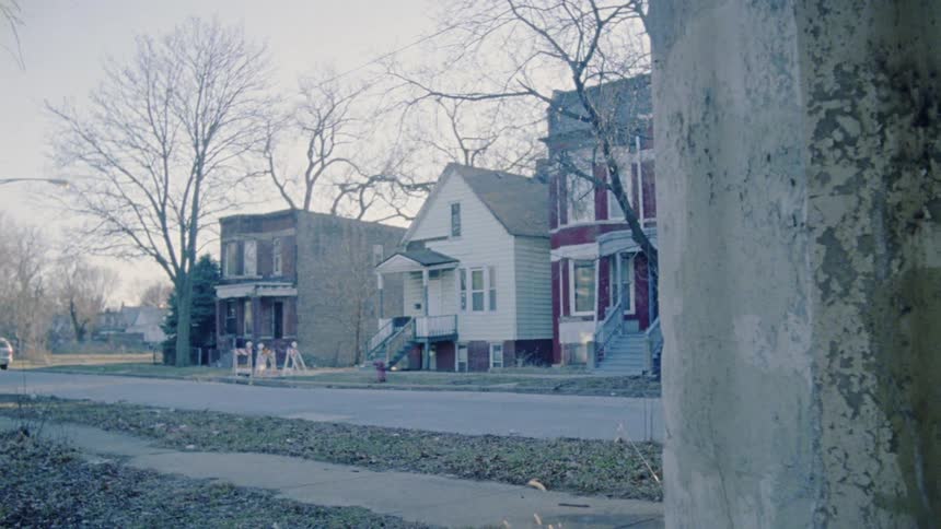 The neighborhood street is empty on a cloudy day