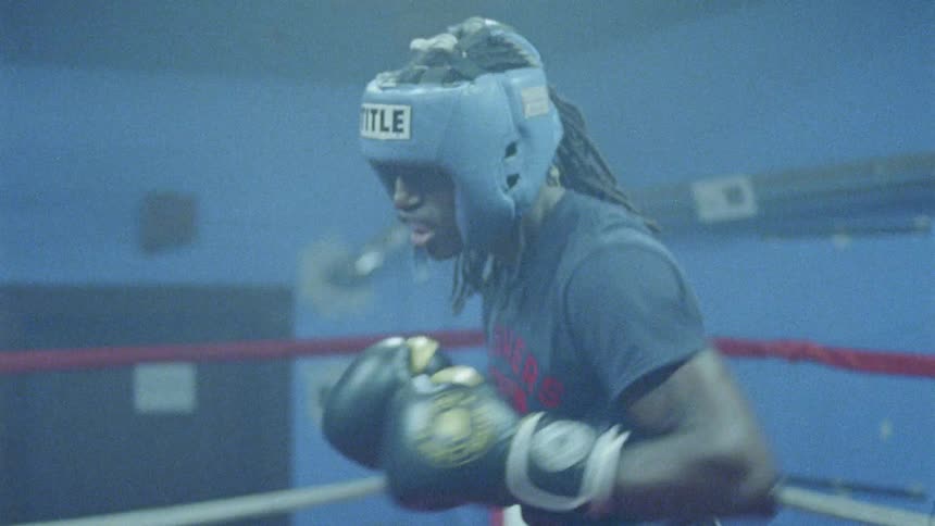 Two people box in a ring