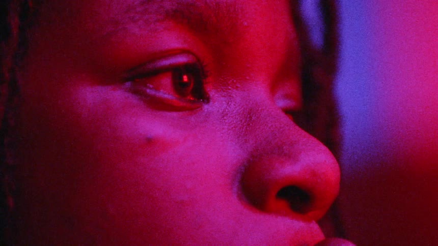Woman blinking with flashing colored lights