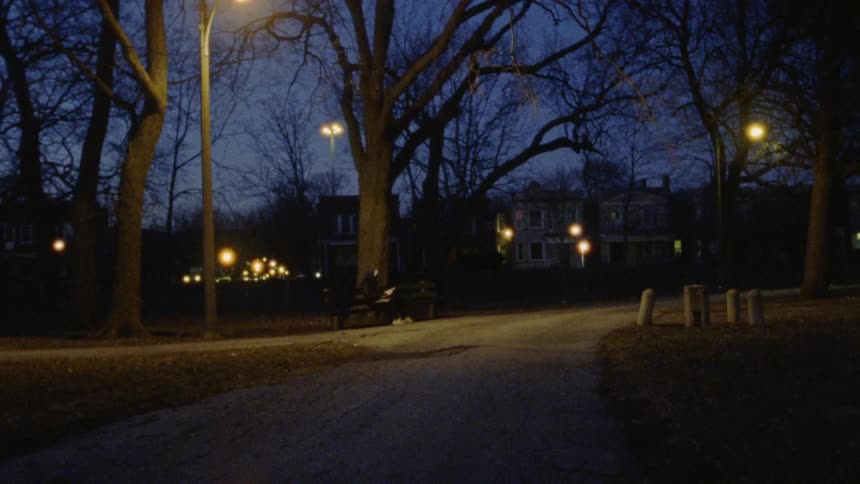 Someone sitting in a dark park