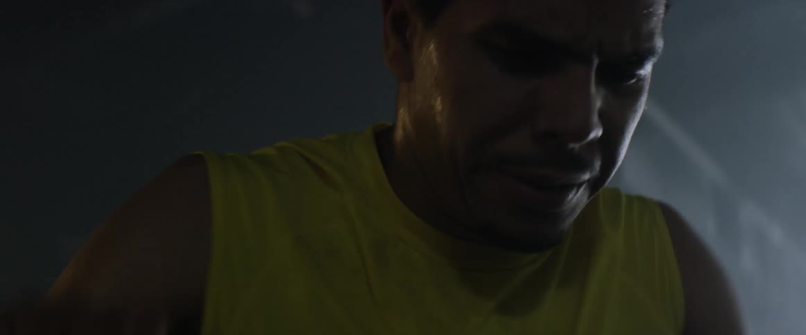 A man sweating while working out on an exercise machine