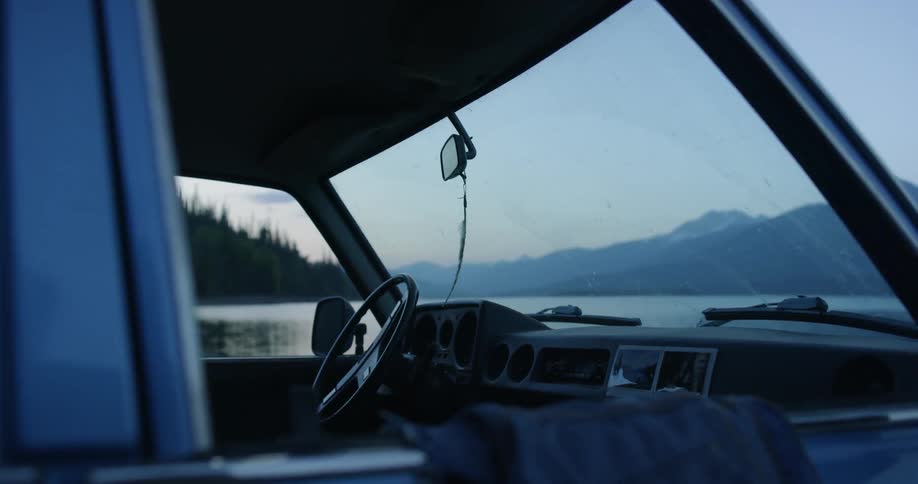 The vehicle is empty by the edge of the lake