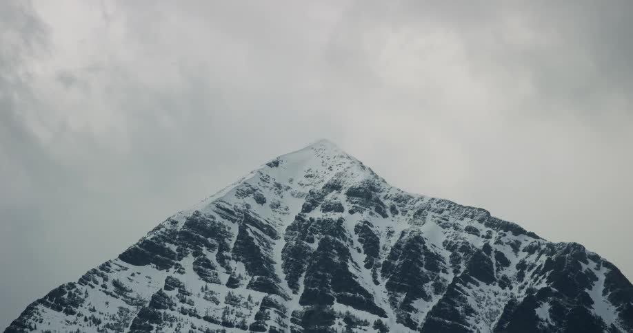 The mountain is covered with ice and snow on a cloudy day