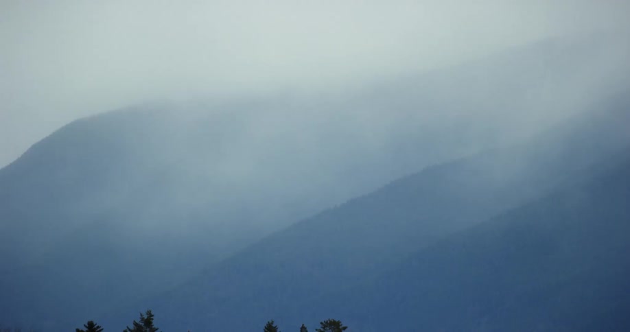 Fog hovers low over mountains