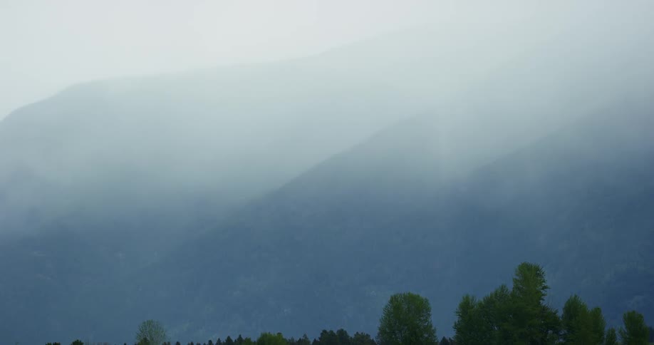 The mountains are covered in thick fog
