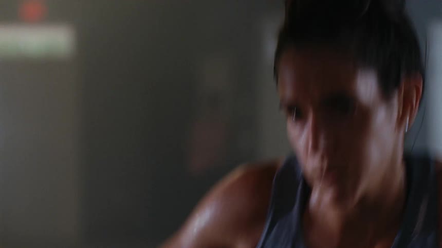 Woman on an exercise machine pumping her arms