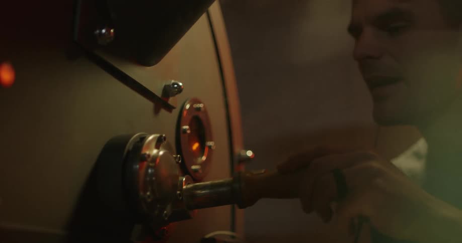 A person is turning a handle on an object