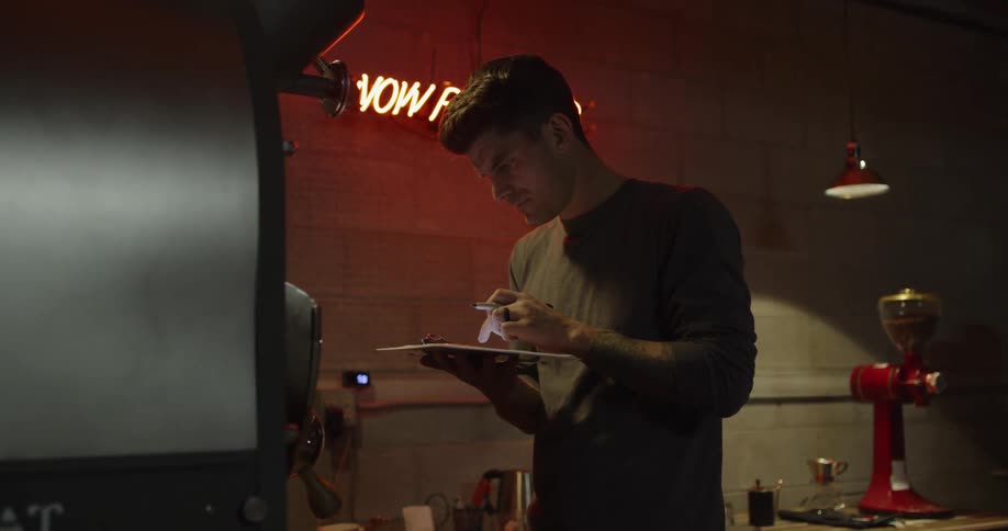 A man is using a tablet in the warehouse