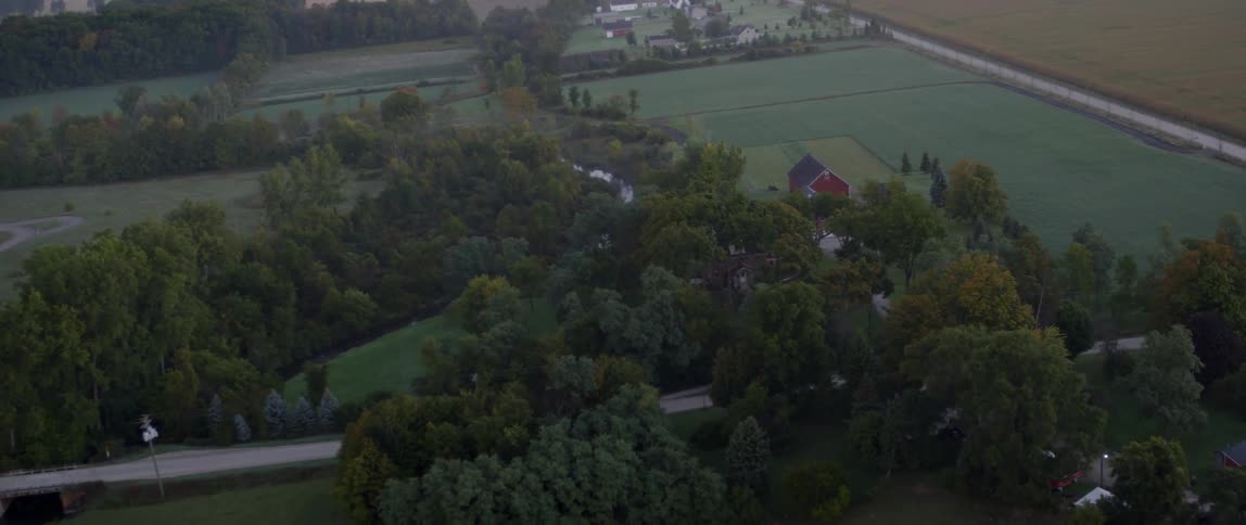 Aerial view of farm fields and trees in the country