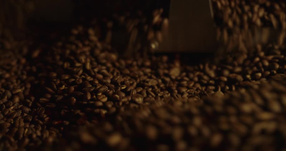 Coffee beans are being stirred by a machine