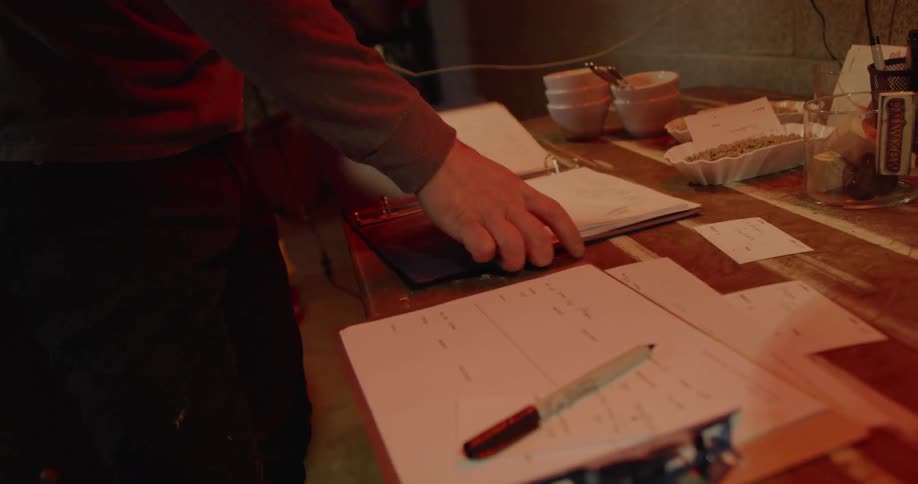 A man arranges papers on a table