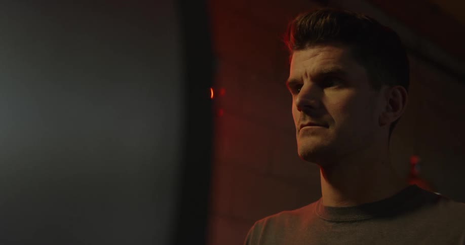 A man is indoors looking around
