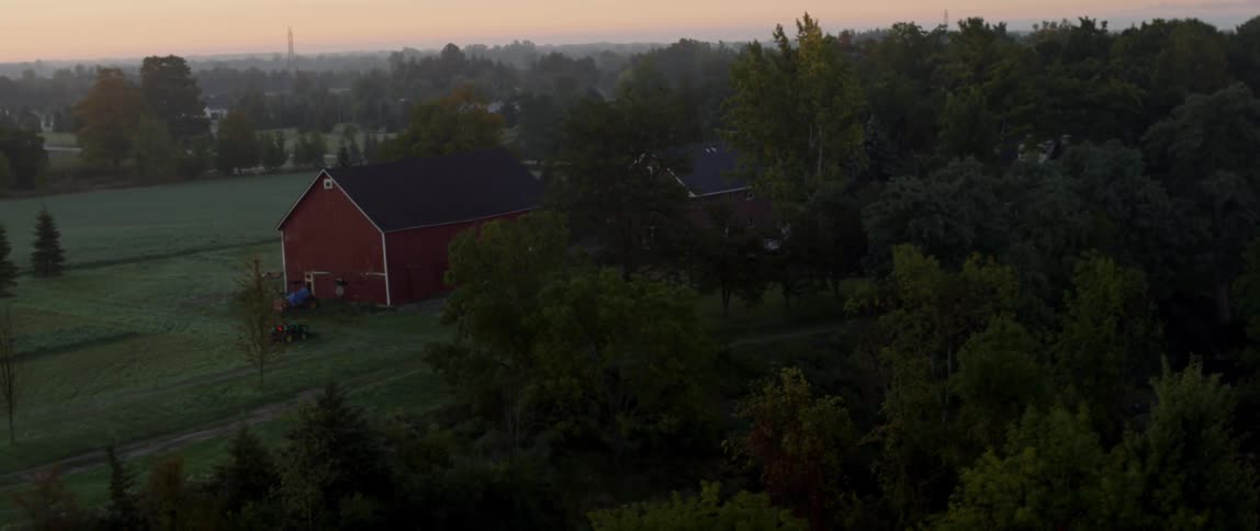 A farm house with a barn on a rural area