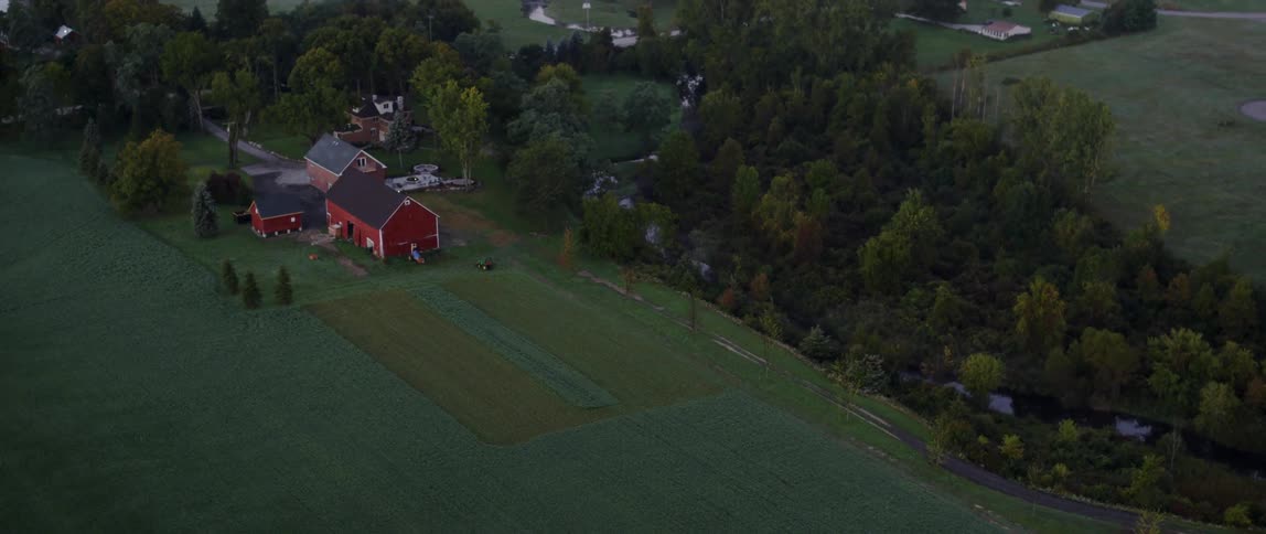 Sky view of red barn in rural town