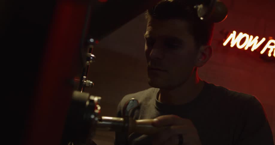 Man turns and pulls out lever in low light