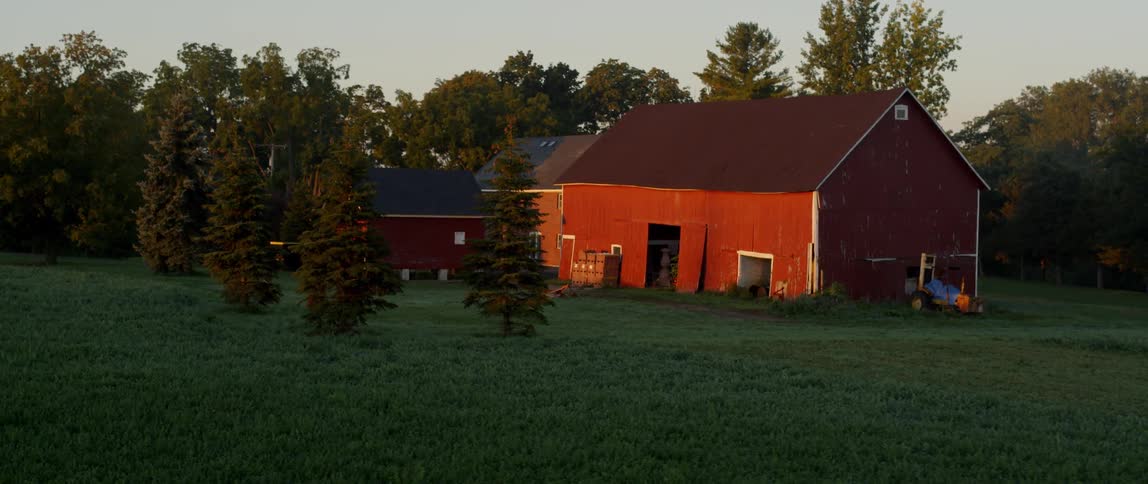 A red barn is in a remote area