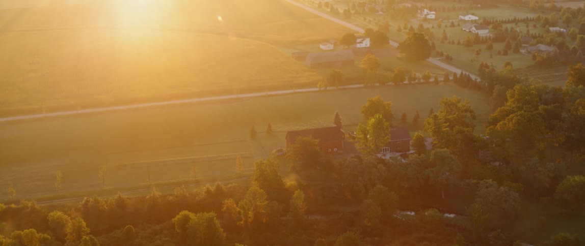 The sun shines brightly on the farmer's fields