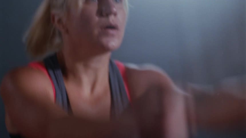 A woman and man working out with heavy ropes