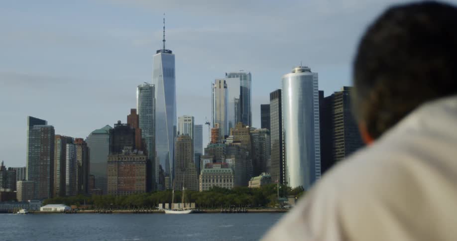 Man looks at the city across the river