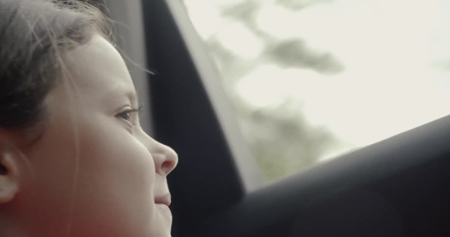 Boy looks out the car window