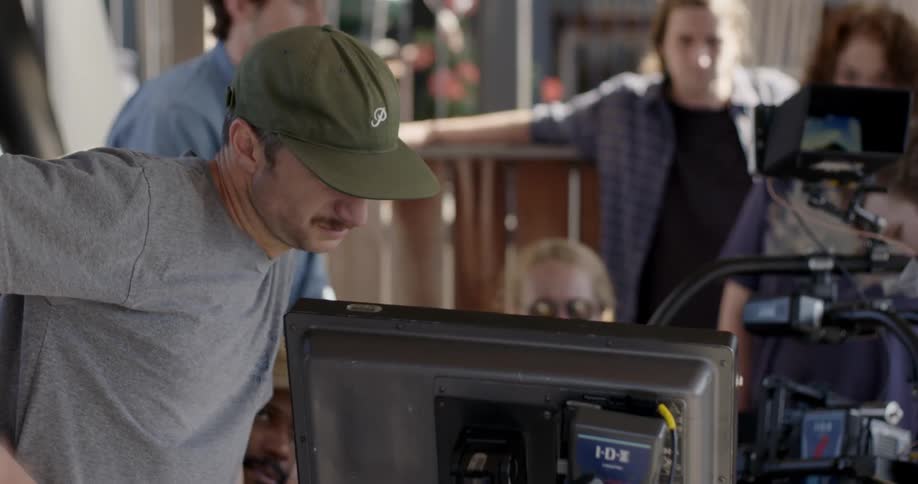 A group of people stare at a computer screen together