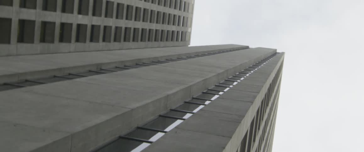 A skyscraper towers into the overcast sky
