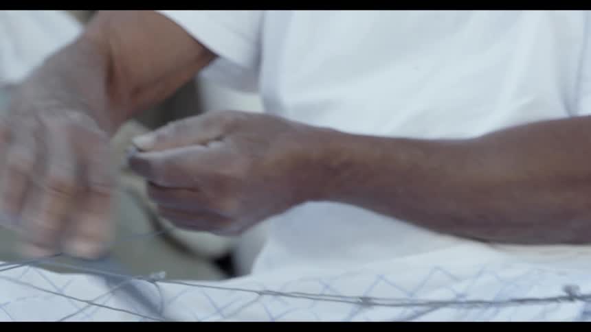 A man is using a tool to create a net