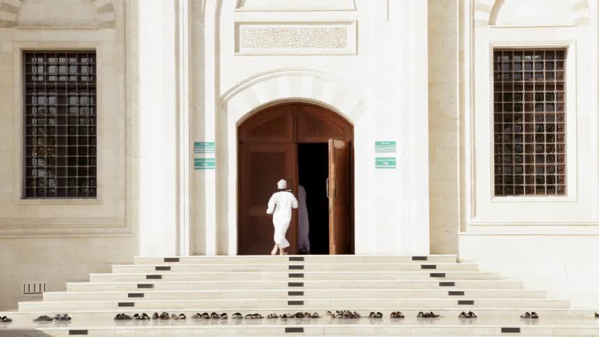 A boy and man race upstairs to a door