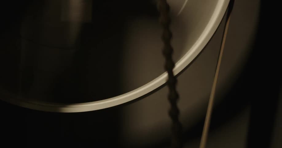 A machine is spinning around while a chain moves up