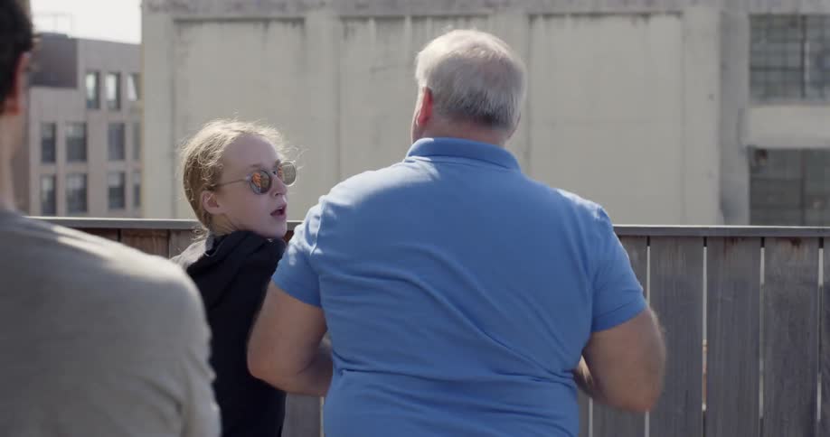 Woman pretends to punch a man in the chin