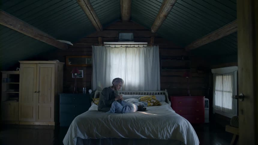 A mother and daughter relax on a bed