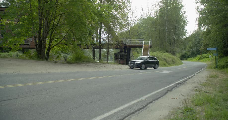A car is driving on a road during daytime