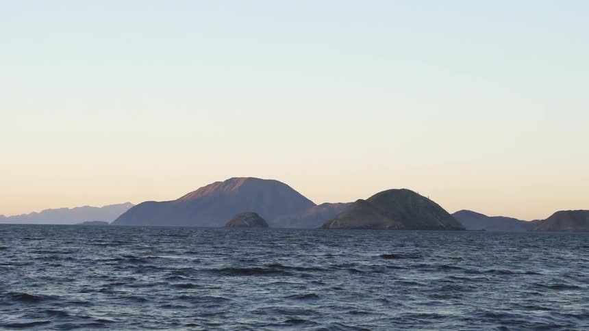 Open water vibrates against the rocks in the distance