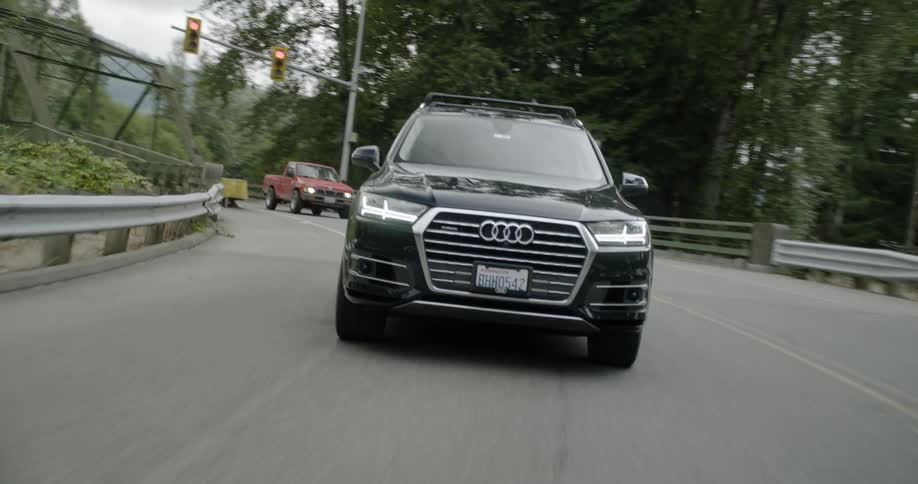 An audi driving on a city road