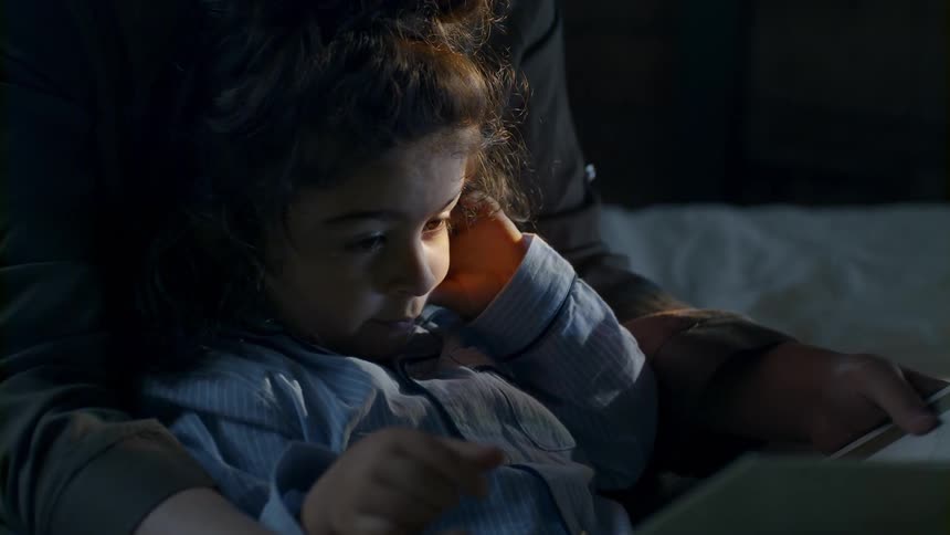 A child reads a story with their parent