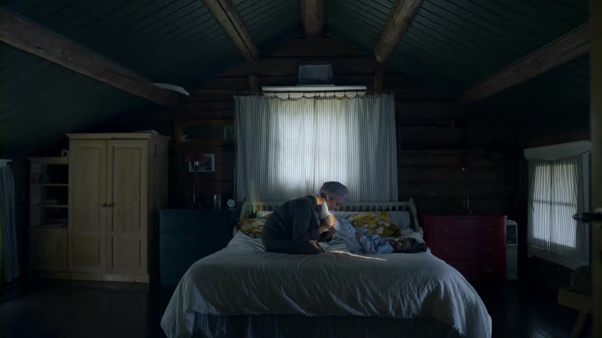 A child and mom are sitting on a bed