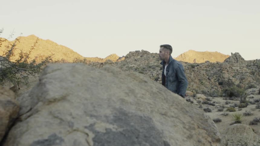 A man is hiking in the desert