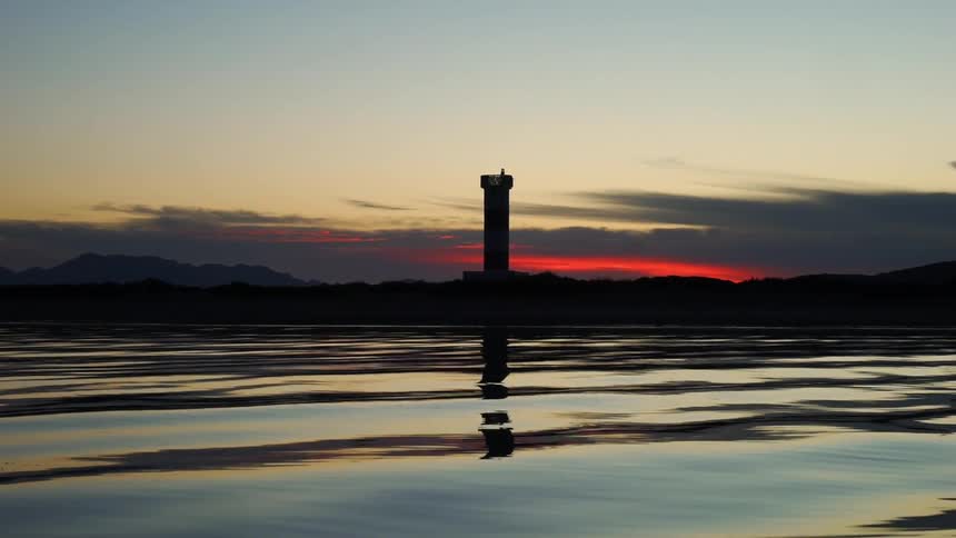 Past the water a tower sits on the island
