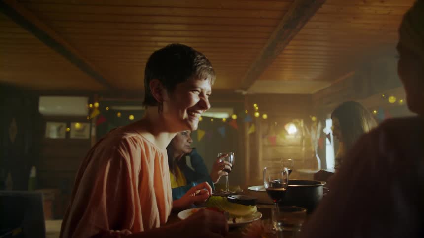 A woman laughing while talking with someone