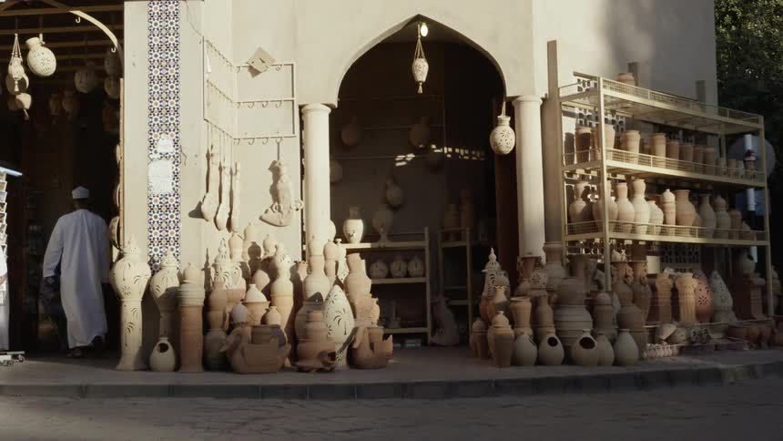 The shop has many vases on display in front