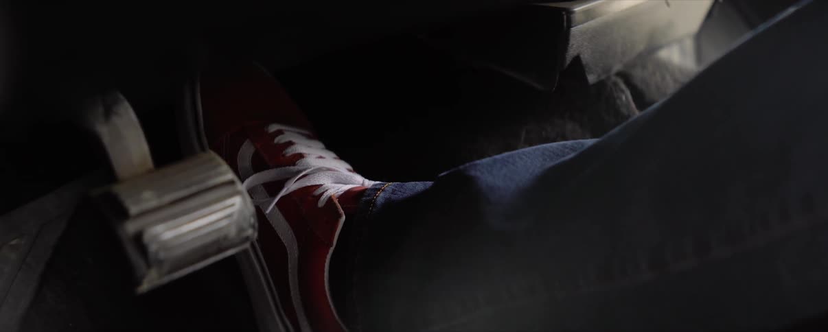A driver presses their foot down on the gas pedal